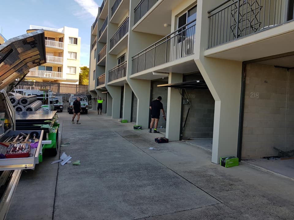 ten tilt garage doors installed at an apartment complex in Caloundra, Sunshine Coast.